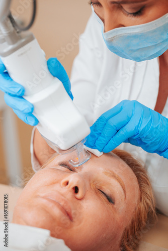 Laser resurfacing and peeling of facial skin - cosmetic medical procedure in a beauty salon