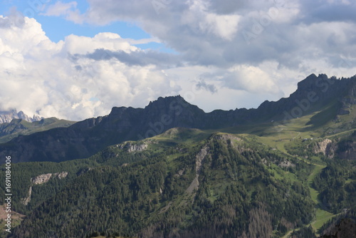 Trentino, Italy - July 29, 2025: Stunning Alpine scenery of breathtaking Dolomites rocks mountains in Italian Alps. Marmolada glacier seen in the distance from the slopes of the Porta Vescovo Dolomite