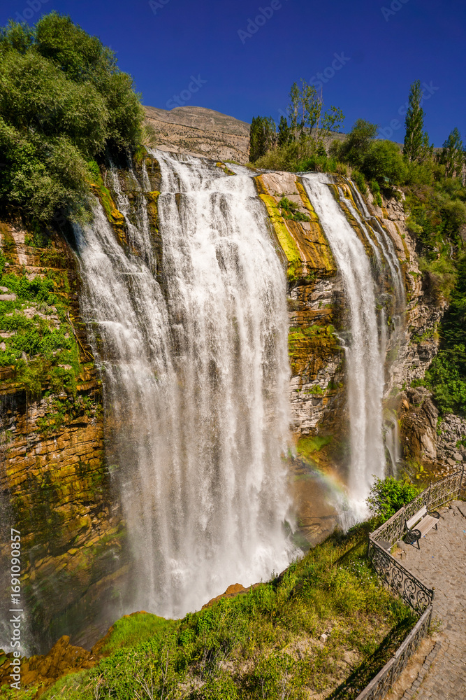 Obraz premium 14 July 2025 Tortum Erzurum. Tortum waterfall, tortum dam, lake and fish farms on the lake on a sunny day.