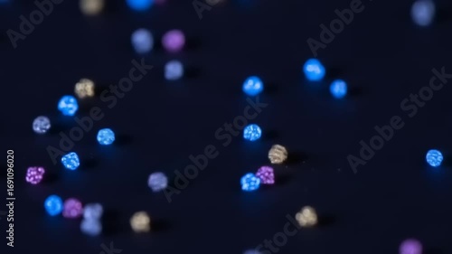 Colorful beads scattered on a dark surface, creating a vibrant and artistic background for crafts