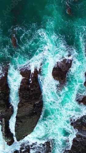 Powerful Ocean Waves Crashing on Rocks – Vertical Seascape Video. Dramatic vertical video of strong sea waves hitting rocky coast, showing nature’s raw power.