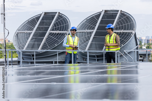 Engineers inspecting rooftop ventilation system installation