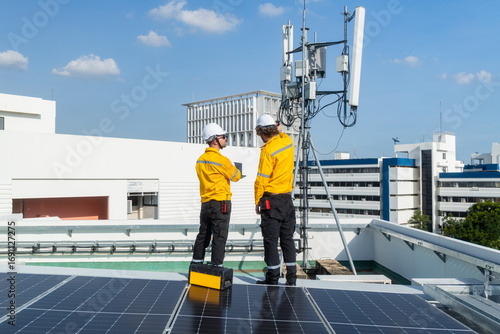 Engineers inspecting rooftop telecommunications tower