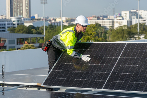Technicians installing solar panel on city rooftop