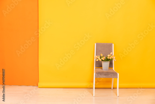chair in the interior of an empty yellow orange room