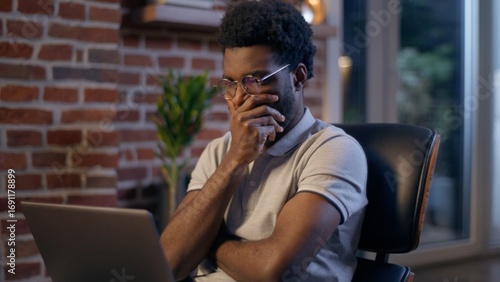 Thoughtful businessman African American guy thinking business man searching idea in evening office consider decision male trader employee think project plan online late working laptop in dark night