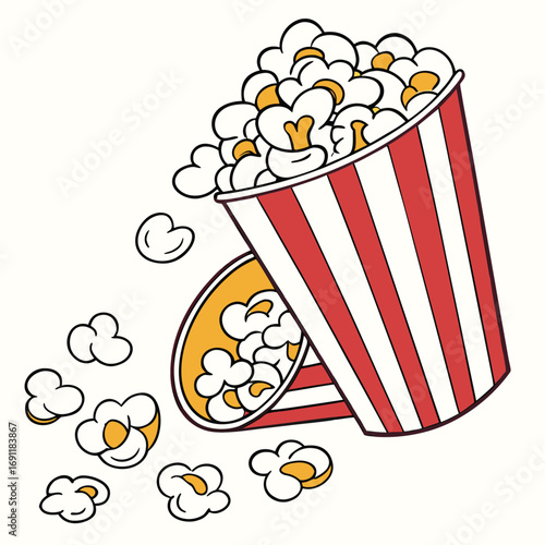 Delicious cinema popcorn overflowing from a classic striped bucket