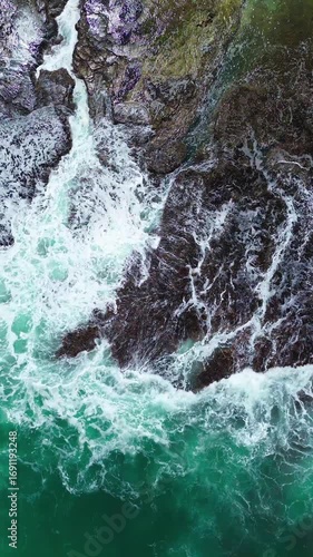 Ocean Waves Crashing on Rocky Coast – Vertical Nature Video. Vertical video of ocean waves hitting rocky shore, perfect for travel, nature, and seascape projects.