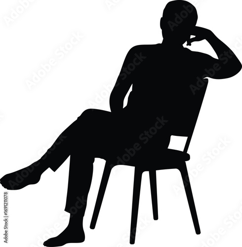 Silhouette of Man Sitting on Chair with Crossed Legs and Relaxed Pose