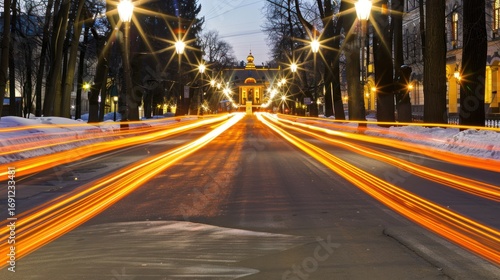 Night Street Scene with Bright Streetlights and Light Trails Leading to Historic Building
