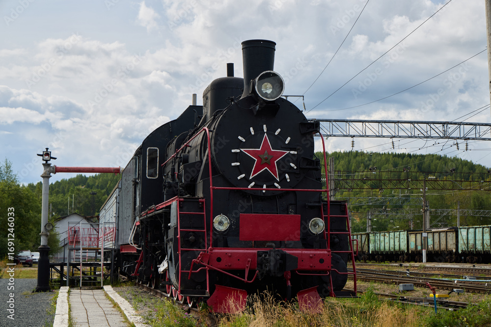 Naklejka premium A beautiful Vintage Soviet Steam Locomotive proudly showcased at the Train Station