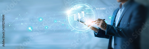 Fototapeta kuchenna Businessman using tab data science icon with global network. Predictive analytics, machine learning, data visualization, big data insights, AI integration, business intelligence.