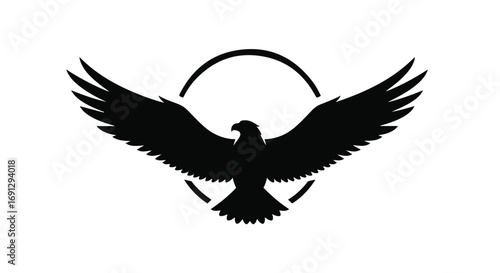 Majestic eagle silhouette with wings spread wide within a circular frame, symbolizing freedom and power.