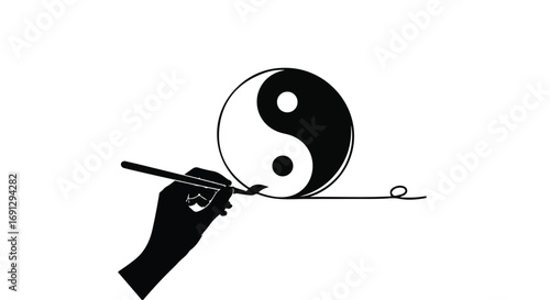 Artist's hand drawing the Yin Yang symbol with a brush, representing balance and harmony