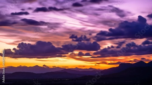 Stunning Sunset over Mountain Range with Dramatic Clouds