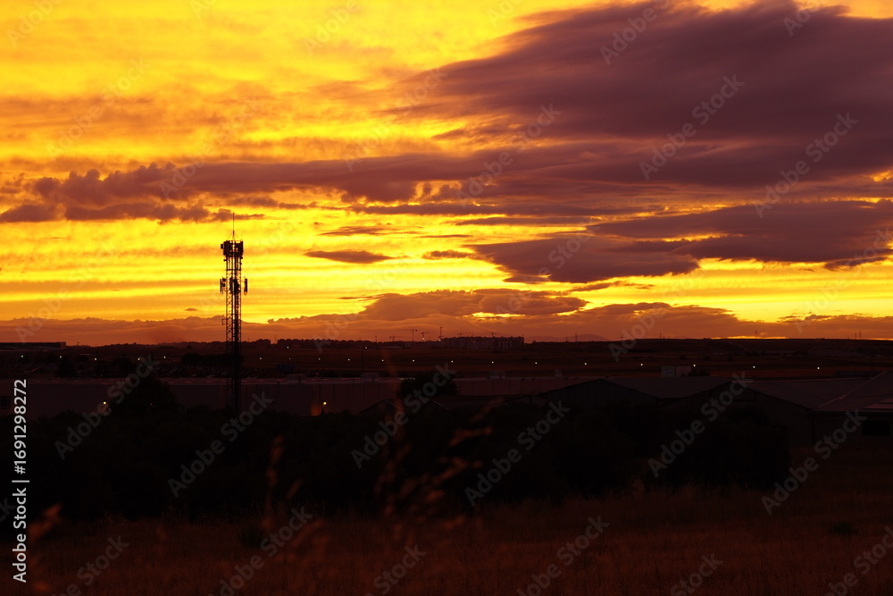 Fototapeta premium Telecommunication tower at sunset with dramatic sky