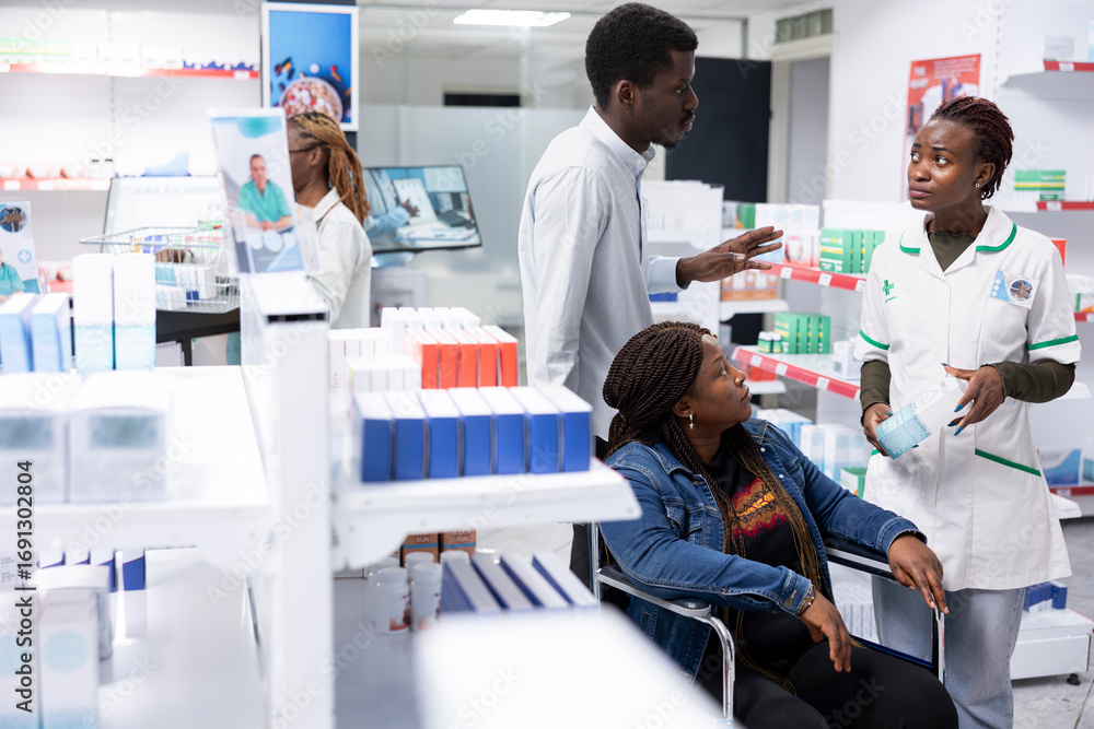 Obraz premium African American health expert advising a woman with impairment about prescription drugs use or medication dosage, pharmaceutical service during a pharmacy retail visit focused on health.
