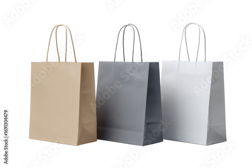 Three paper shopping bags in beige gray and white colors isolated on a transparent background image