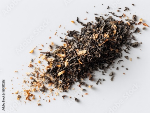 Loose leaf blend of dark tea, light spices, scattered on white