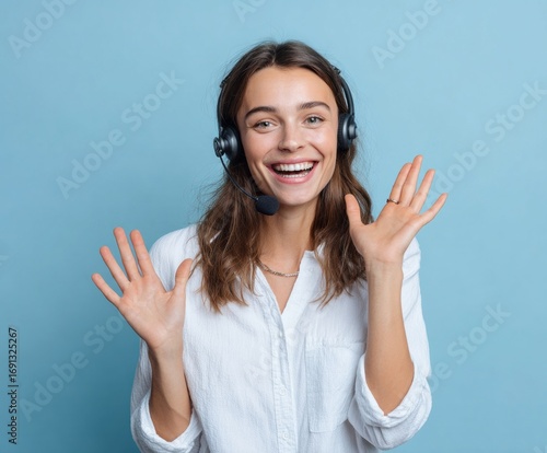 A joyful customer service representative with a headset, beaming and gesturing warmly against a simple backdrop, exudes positive energy and welcome.