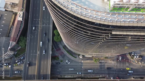 Aerial top view of skycrapper with reflection in glass busy traffic in big city, 4k