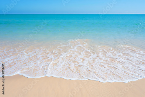 Sandy beach with blue sea and clear sky