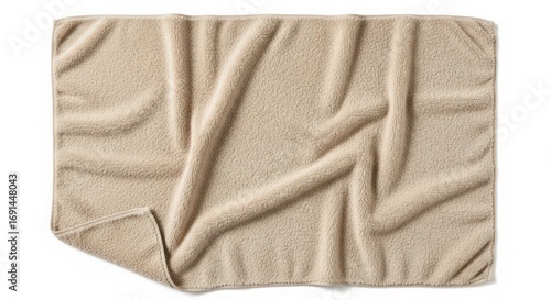 Soft beige blanket draped casually on a flat surface, showcasing its texture and warmth