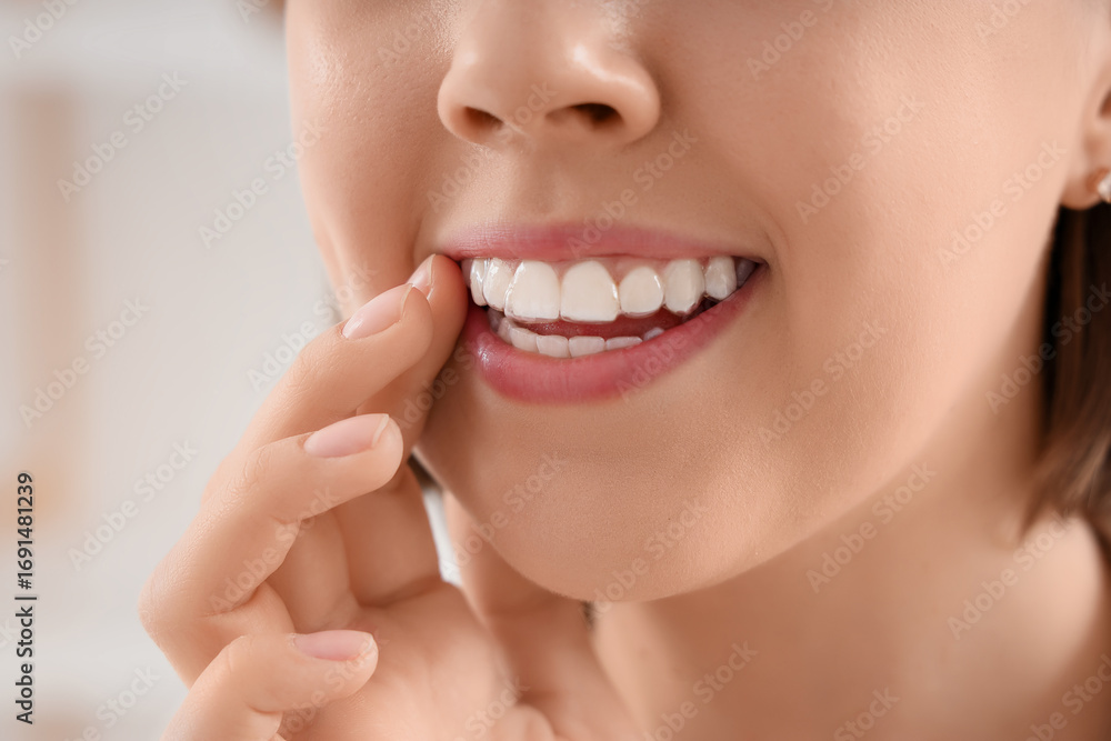 Obraz premium Young woman with occlusal splint in bathroom, closeup