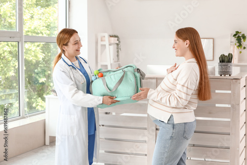 Young pregnant woman and do...