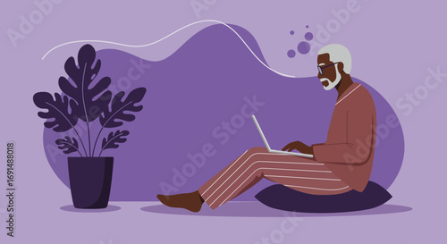 Senior man with glasses focused on working or learning remotely on his laptop while sitting comfortably at home. Modern digital lifestyle.