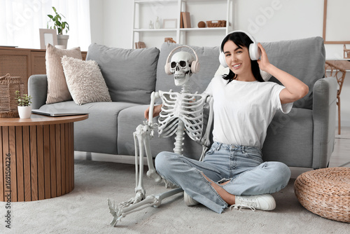 Young woman with human skel...