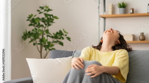 Joyful Woman Laughing Freely in Cozy Living Room