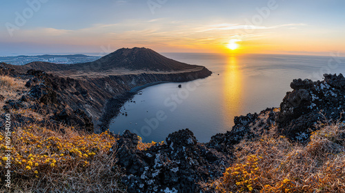 Breathtaking panoramic view of Seongsan Ilchulbong Peak at sunrise, showcasing vibrant colors of sky reflecting on calm sea