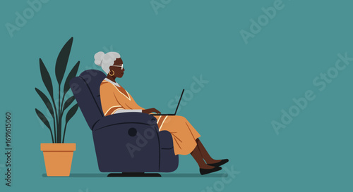 Elderly African American woman comfortably using a laptop in a recliner chair at home, symbolizing digital engagement and relaxation for seniors.