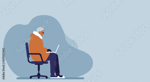 Senior man with glasses and a warm coat focused on working or learning on his laptop, representing digital literacy and active aging.