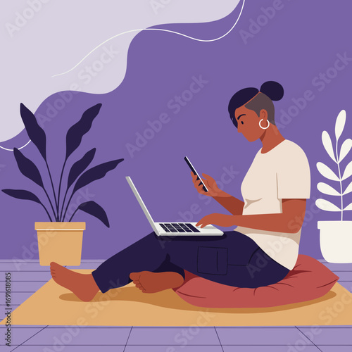 Young woman comfortably working from home, multitasking with a laptop and smartphone. Represents remote work, freelancing, and digital connectivity in a modern lifestyle.