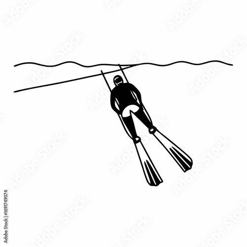 Diver with fins swimming underwater near surface waves freediver free diving