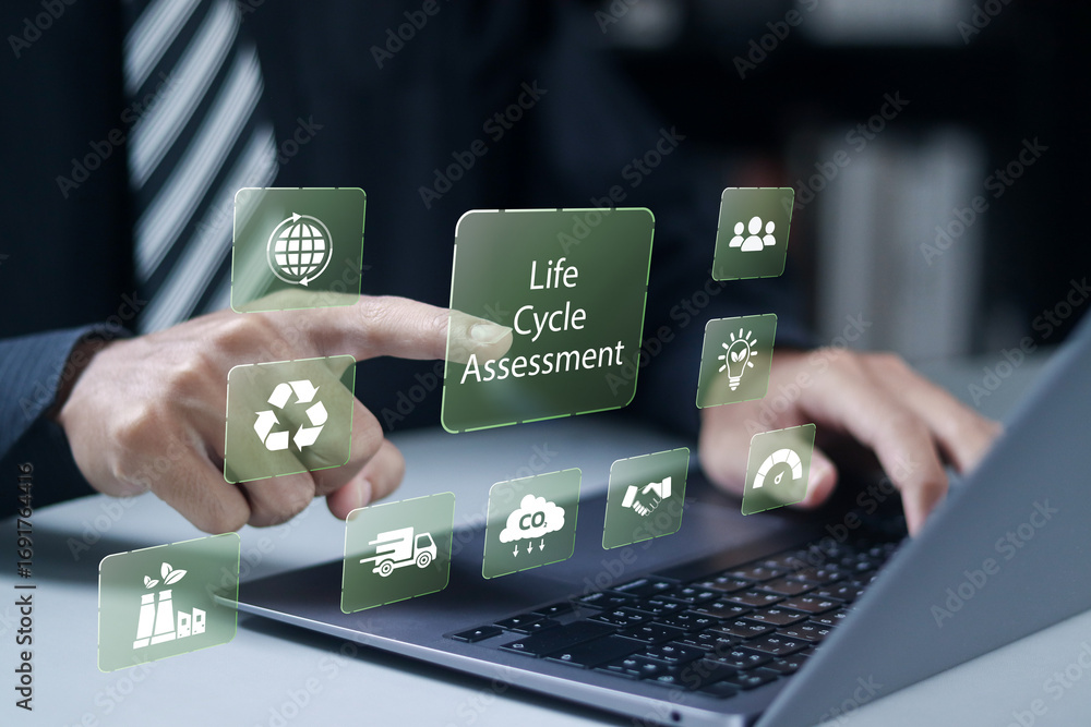 Naklejka premium LCA, Life cycle assessment concept. Carbon footprint evaluation and environmental impact assessment related to product value chains. Businessman use laptop with virtual icons.