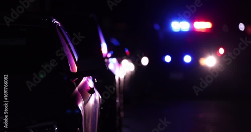 Abstracted view of police car pulling over a vehicle on a city street at night.