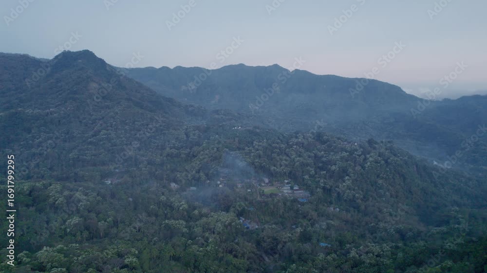 Beautiful view of Mount Inerie volcano during afternoon with lush tropical forest and soft mist. Ideal for nature, travel, adventure, landscape, and tourism themes. Beautiful view of Mount Inerie volcano during afternoon with lush tropical forest and soft mist. Ideal for nature, travel, adventure, landscape, and tourism themes.