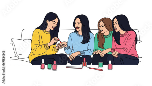 Four young women friends gathered together on a couch painting each others fingernails with colorful nail polish bottles and brushes