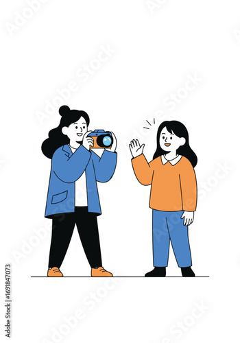 Two girls taking a picture with a camera one girl is waving at the camera to capture a memory