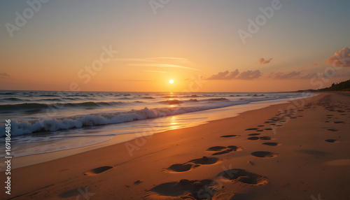 Wallpaper Mural Golden hour sunset paints tranquil beach scene with gentle waves and footprints marking a peaceful journey. Torontodigital.ca