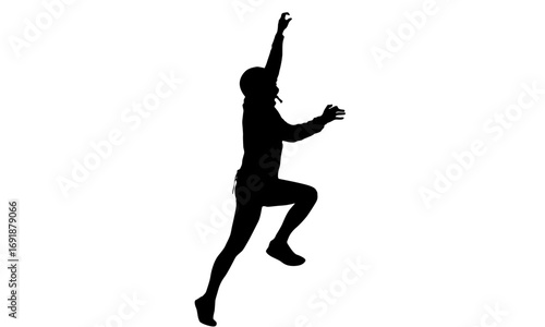 Silhouette of a person climbing or jumping.