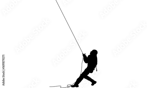 Silhouette of a person rappelling down a rope, demonstrating climbing and outdoor activity.