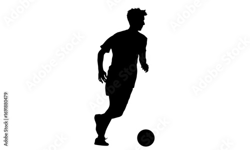 Silhouette of a soccer player dribbling the ball.