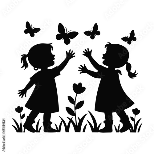 Black silhouette of two young girls reaching for butterflies in a grassy field with flowers children