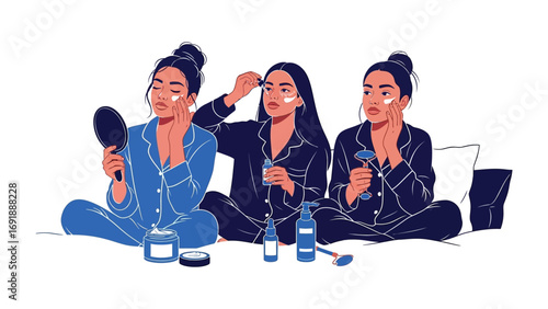 Three stylish young women in matching pajamas applying makeup and skincare products while sitting on a bed enjoying a pampering session together
