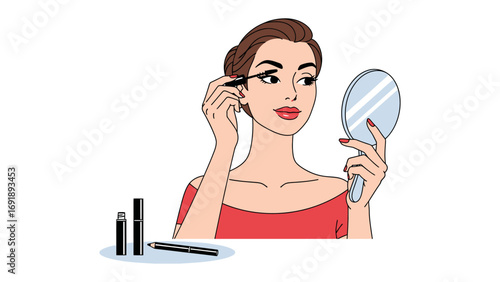 A beautiful woman with dark hair applying mascara to her eyelashes while looking in a handheld mirror with makeup products nearby