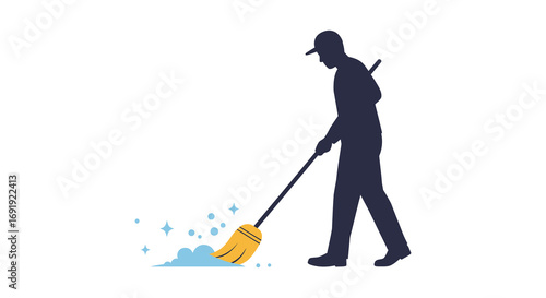 a worker sweeping floor with broom creating cleanliness
